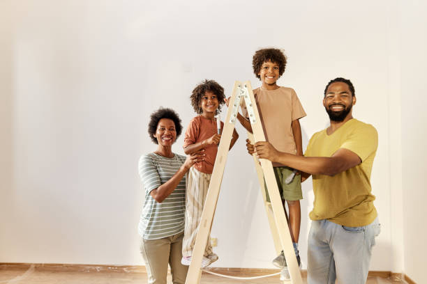 istock Happy black family on ladder during home renovation process. 1421527953