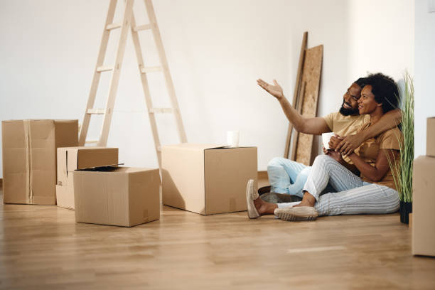 istock Happy black couple making plans after moving into a new apartment. 1421528014