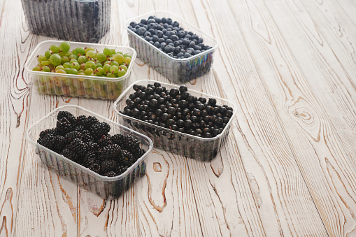 berries in plastic containers, food for customers, raspberries, currants, blackberries, gooseberries, blueberries, blueberries