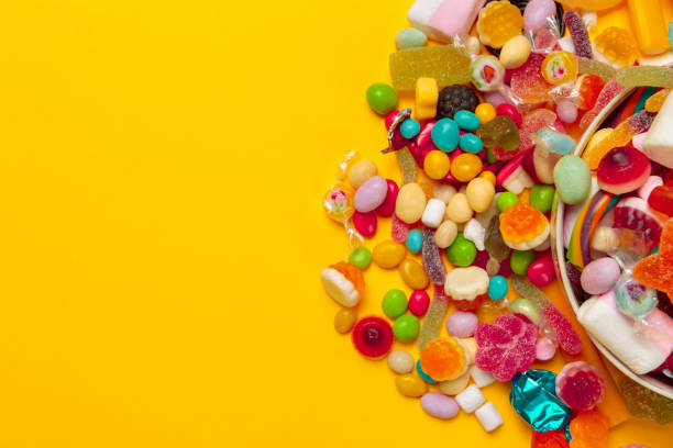 istock colored candies on yellow background 1421529192
