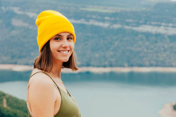 istock Young cheerful girl on top rocky mountains 1421530491