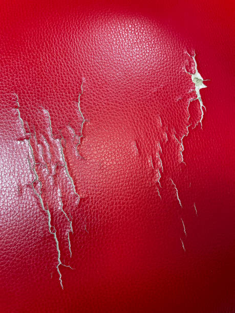 istock Full frame image of abstract, cracked red leather background wallpaper, textured ripped and torn leather surface, aged, elevated view 1421532912