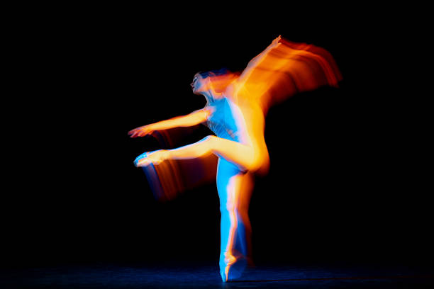 istock Young and graceful female ballet dancer dancing over dark background in mixed neon light. Art, motion, action, flexibility, inspiration concept. 1421534251