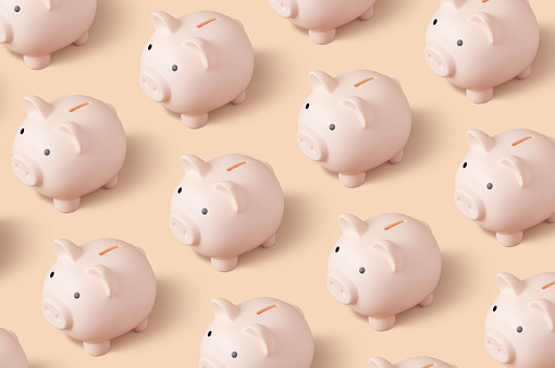 Group of piggy banks on beige background, seamless tabletop banner