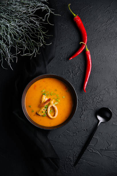 istock Tom yam seafood soup from above on black stone 1421537016