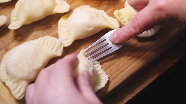 Preparing dumplings. Following a traditional recipe. Decorating the edges of the dumplings. Version 3