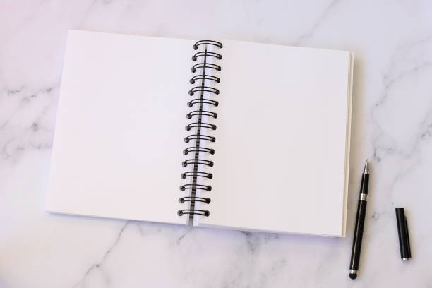 istock Open notebook and black pen, blank paper, mock up 1421541450