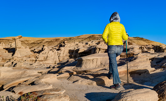 Female Hiker in Bisti Badlands / De-Na-Zin Wilderness Area at Sunset, New Mexico, USA