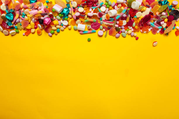 istock colored candies on yellow background 1421544960