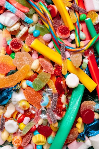 istock Colorful candies on old background 1421544987