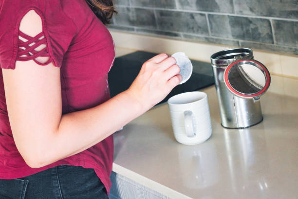 istock A young woman adding a round teabag to a mug in a modern domestic kitchen 1421545912