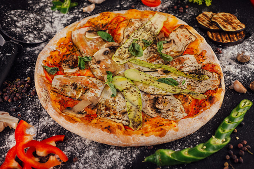 italian vegetarian pizza with zucchini, eggplant, mushrooms and tomato