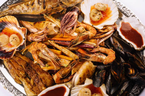 istock fresh shrimp, scampi, mussels, squid, octopus and scallops 1421547054