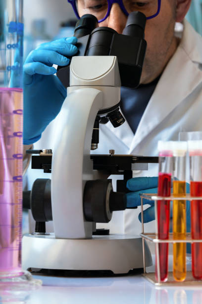 istock Chemist looking in the microscope sample for analysis in the research lab 1421547353