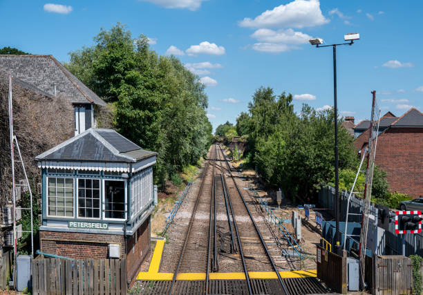 Signal box alongside railroad lines by crossing. Signal box at Petersfield station along side the railway tracks petersfield stock pictures, royalty-free photos & images