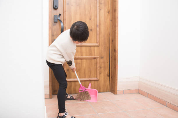 Japanese elementary school boy cleaning the entrance