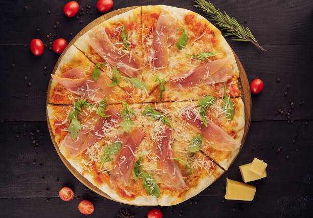 istock Delicious italian pizza with parma ham and rocket 1421554660