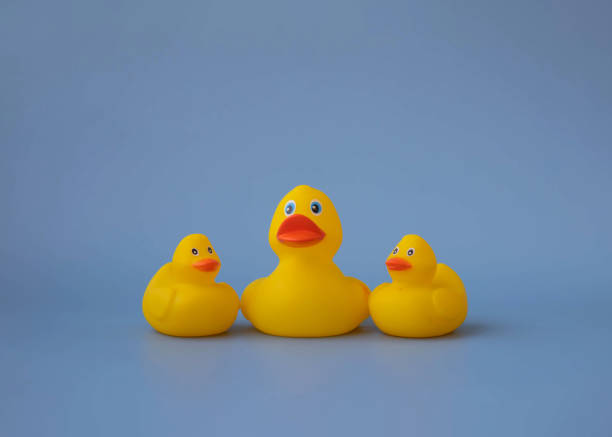 istock Three yellow rubber toy ducks for swimming on a blue background 1421555517