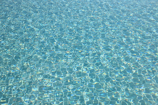 Water surface of a pool on a bright day
