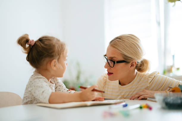 istock Portrait of Mother and Daughter Bonding While Drawing 1421557885