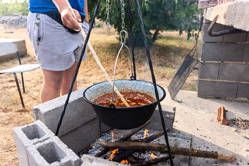 Close-up of cooking in a pot over a fire in the yard