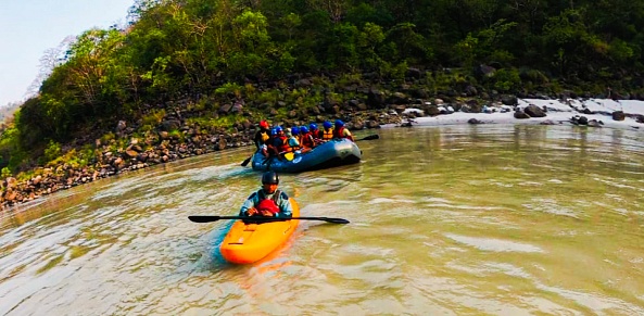 Rishikesh, India-September 7 2022: Young people enjoying  river rafting, kayak in River Ganges, Rishikesh.