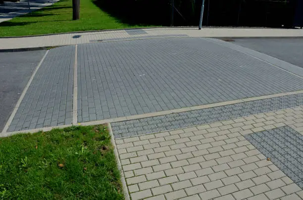 in the middle of the road leading to the residential area, the police and the traffic office installed cobblestone retarder. raised square made of rubber beveled on sides, bumpy, two, paving