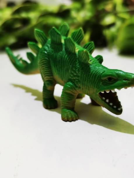 istock Green dinosaur toy with a stegosuarus shape 1421567896