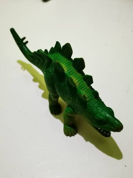istock Green dinosaur toy with a stegosuarus shape 1421567961