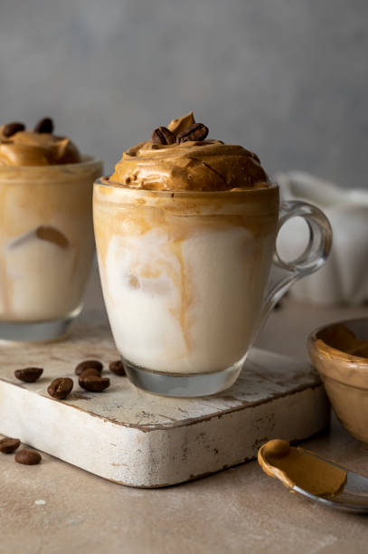 istock Dalgona coffee in glass cups, coffee beans. Moody neutral, warm backgroung with copy space 1421570062