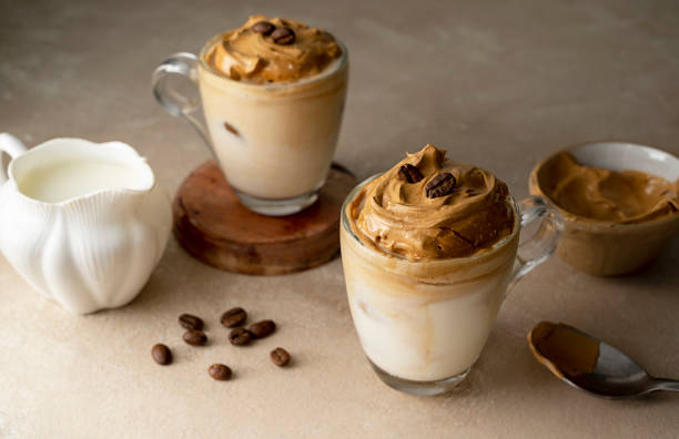 istock Dalgona coffee in glass cups, coffee beans. Moody neutral, warm backgroung with copy space 1421570101