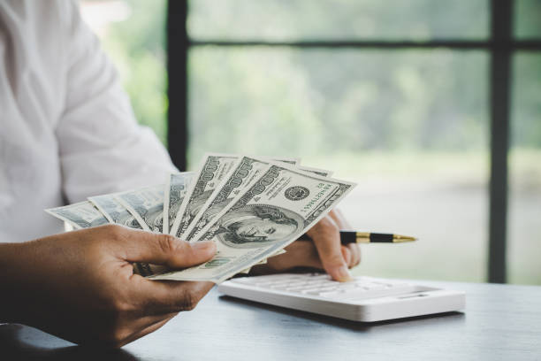 istock a woman makes calculations, checks her finances, makes notes in a notebook 1421570942