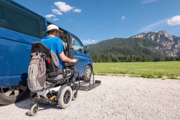 istock Man with disability using wheelchair lift to get in the van 1421571582