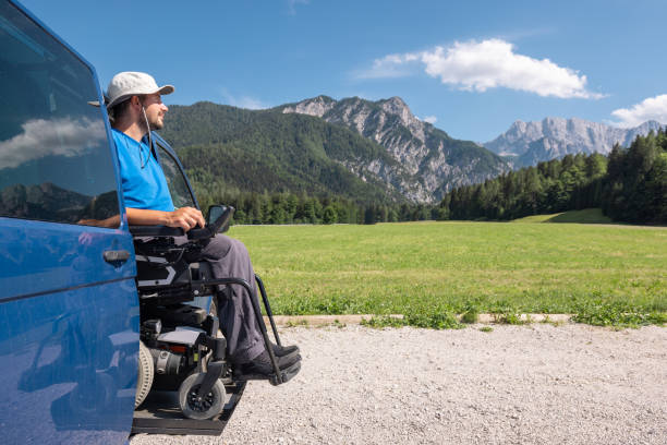 istock Man getting out the van by using a wheelchair car lift 1421571824