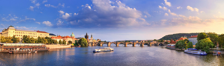 City summer landscape at sunset, banner - view of the Charles Bridge and the Vltava river in the historical center of Prague, Czech Republic