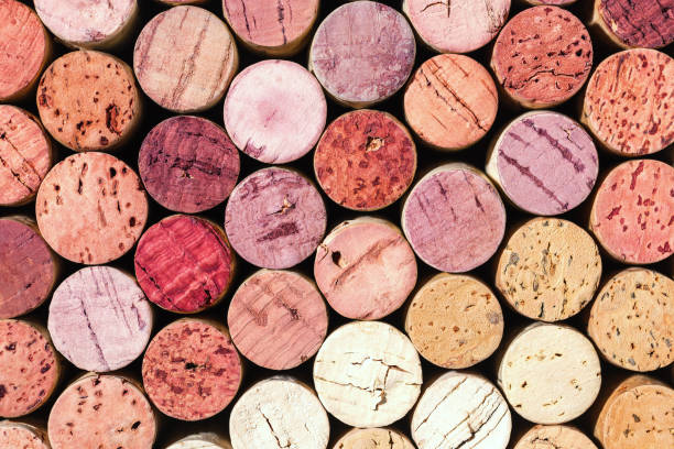 wine cork background from red and white wine, natural texture used bottle stoppers top view. closeup wooden corks. natural textured stoppers colored wallpaper. bright background wine corks - wine bottle wine wood bottle stopper imagens e fotografias de stock