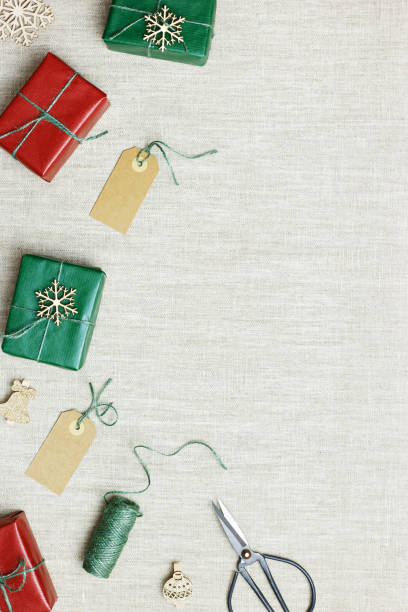 istock Christmas and New Year gift boxes, zero waste, eco friendly packaged gifts in kraft colored paper, green fir tree branches on table, preparation colorful xmas presents, eco christmas concept 1421573847