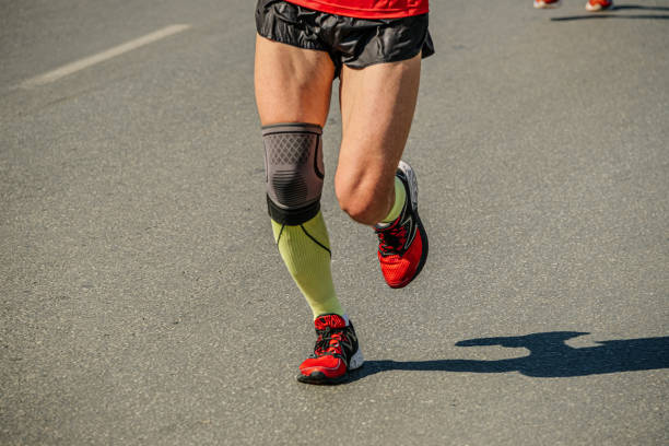 legs man runner running with knee pad protection legs man runner running with knee pad protection kneepad stock pictures, royalty-free photos & images