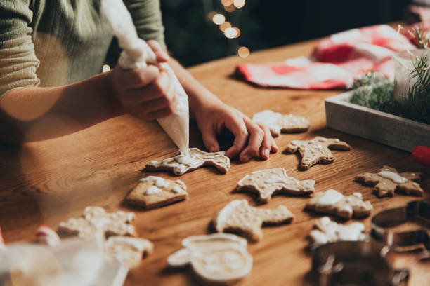 istock Christmas, New Year food preparation. Gingerbread cookies decorating with icing 1421574484