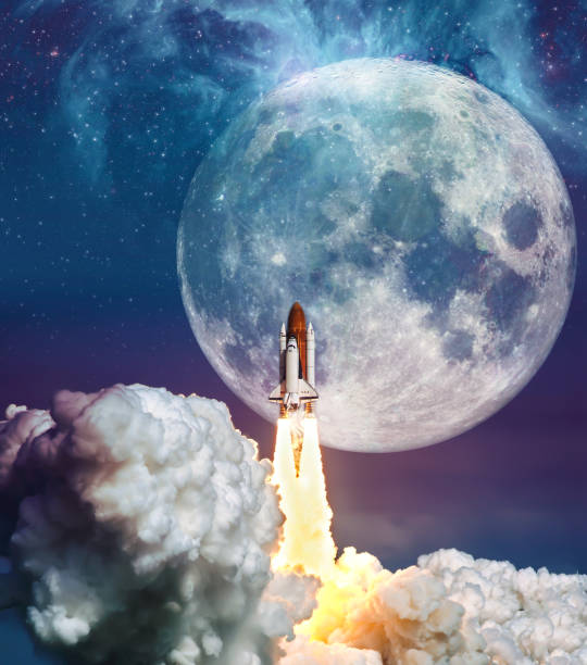 istock Cloudy launch of rocket Space Shuttle into colorful starry outer space and the full moon. 