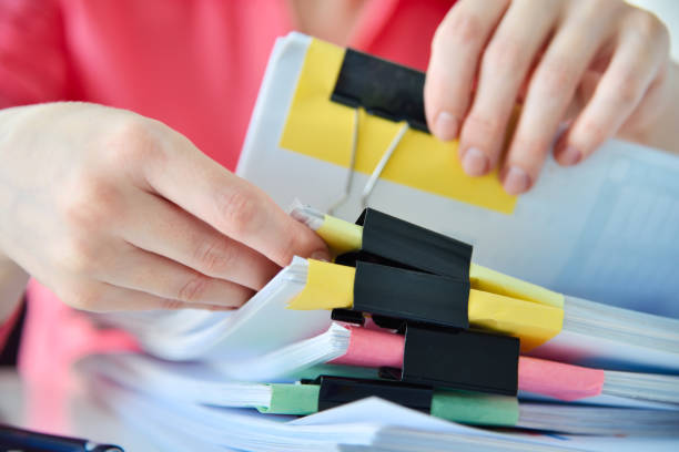istock Accountant or businesswoman hands sorting business reports 1421580348