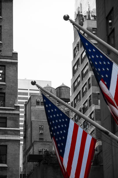 istock American Flags on Flagpoles - selctive colour 1421580997