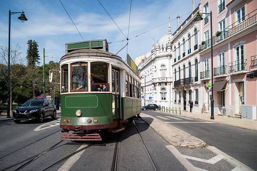 Tourist green tram riding downtown, Lisbon, Portuga