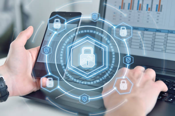 istock Businessman smartphone and digital lock icon hologram with digital shield. 1421582821