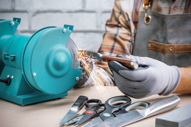 istock Man sharpening the knife. Small business. 1421584073
