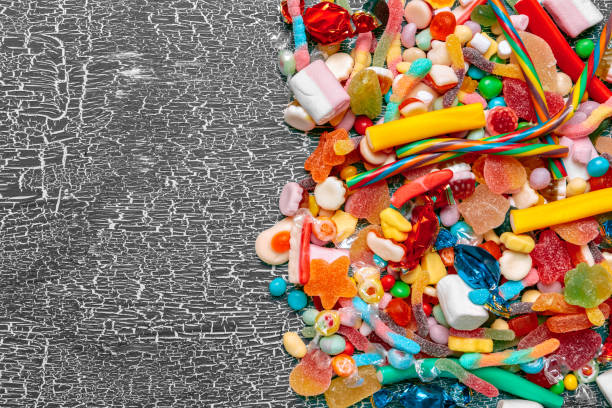 istock Colorful candies on old background 1421584130