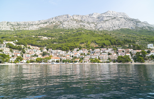 Sea coast with town in Croatia. View of the town of Brela from the Adriatic Sea.