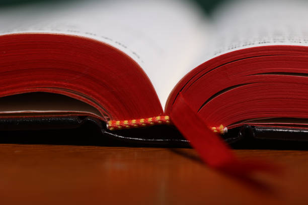 istock Open Holy Bible on a old brown wooden table. 1421587953