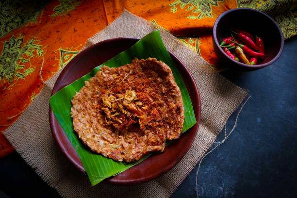 istock kerak telor or Egg Crust. kerak telor is Spicy Glutinous Rice Omelette with Grated Coconut. made from glutinous rice cooked, egg, serundeng, fried shallots and dried shrimp topping. 1421587958