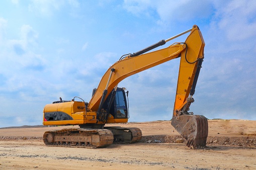 excavator or backhoe on construction site and sky background